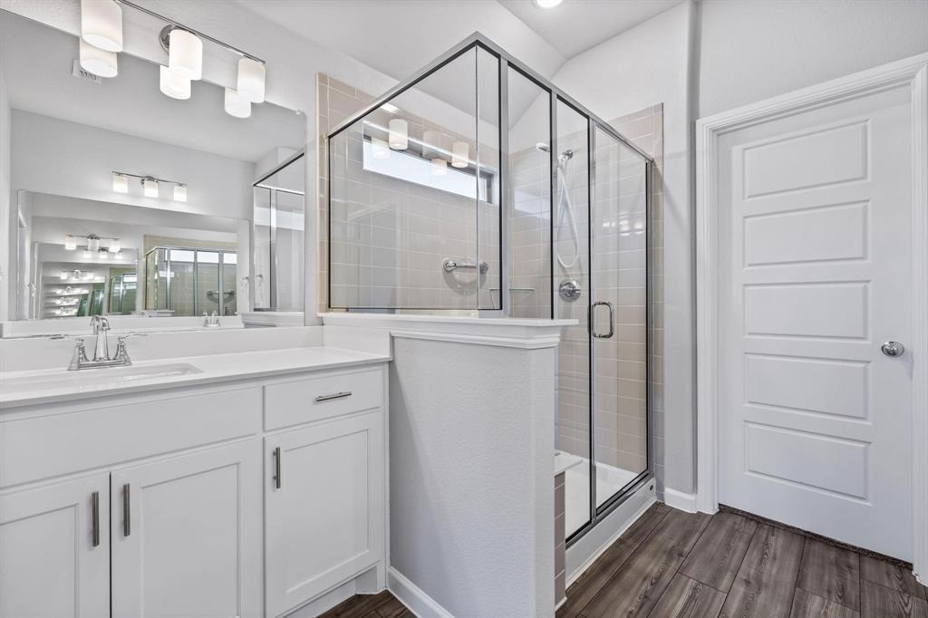 620 Shade Tree Way Princeton, TX 75407 - Photo 20 of 35 a bathroom with a double vanity sink and mirror
