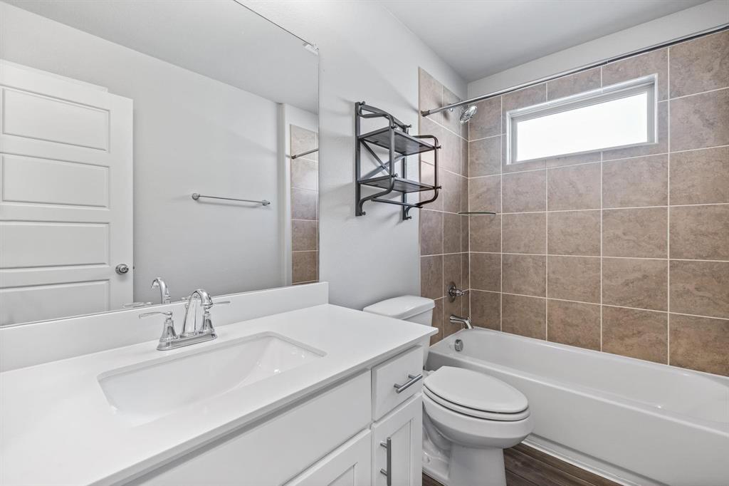 620 Shade Tree Way Princeton, TX 75407 - Photo 26 of 35 a bathroom with a sink a toilet and shower