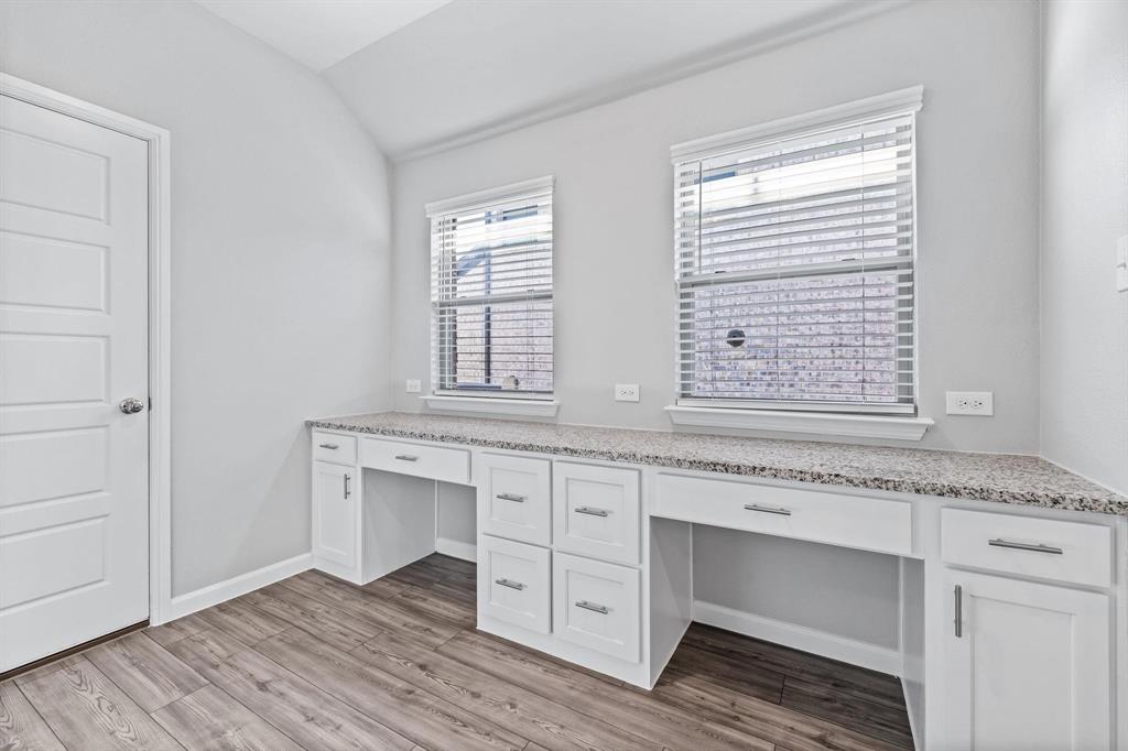 620 Shade Tree Way Princeton, TX 75407 - Photo 28 of 35 a hall with cabinets wooden floor and a window