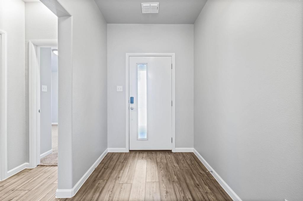 620 Shade Tree Way Princeton, TX 75407 - Photo 4 of 35 a view of a hallway with wooden floor