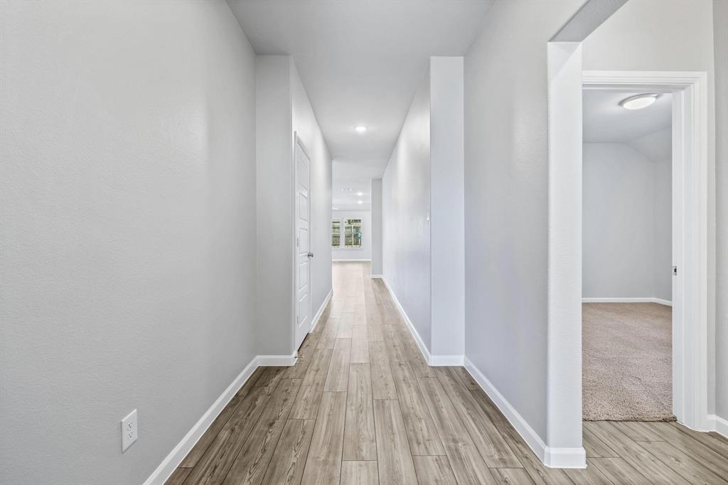 620 Shade Tree Way Princeton, TX 75407 - Photo 5 of 35 a view of a hallway with wooden floor