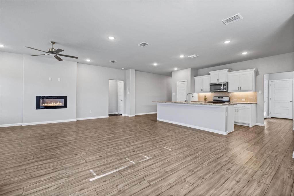 620 Shade Tree Way Princeton, TX 75407 - Photo 10 of 35 a view of kitchen with wooden floor and window