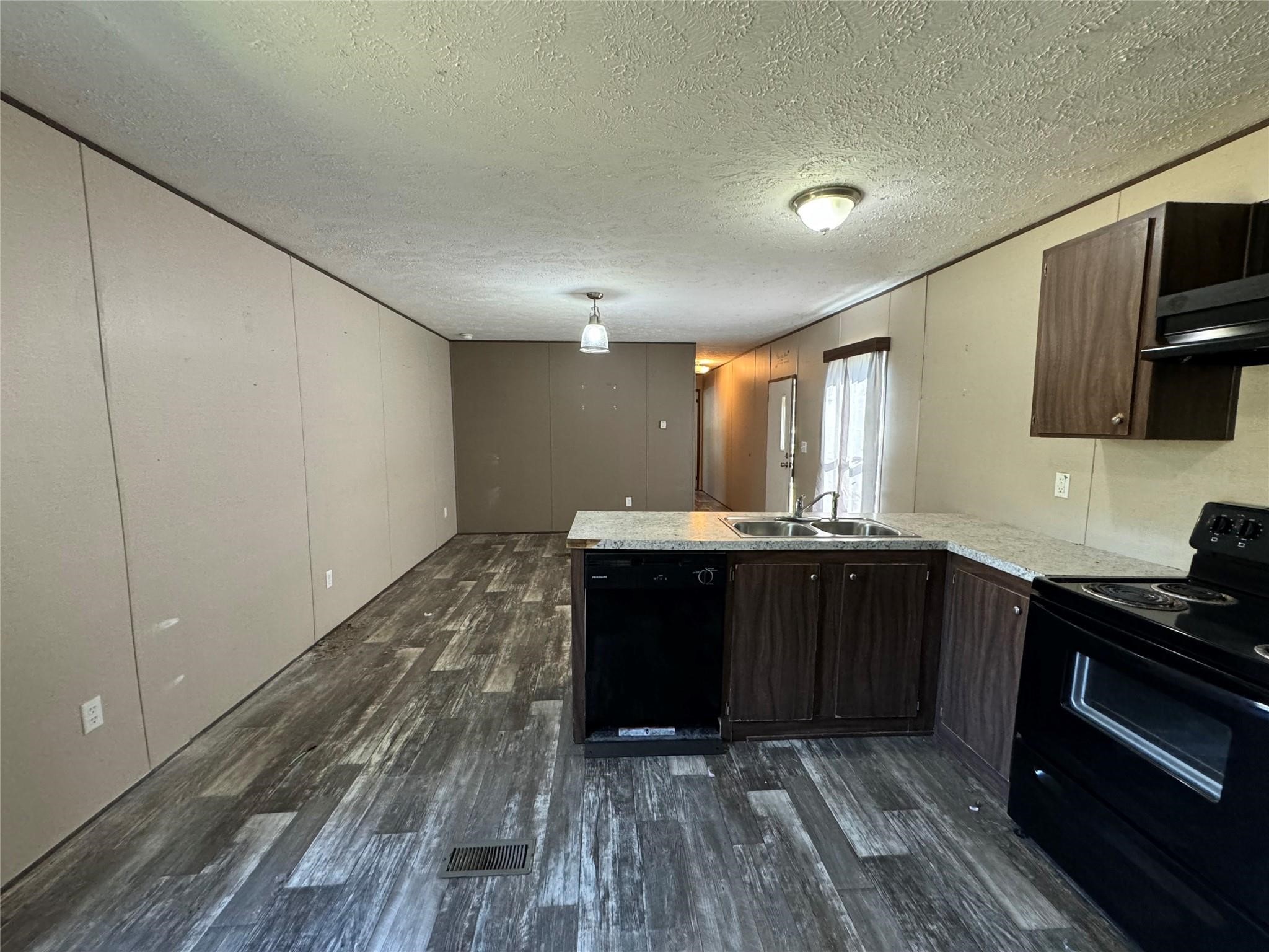18093 Pickering Road Conroe, TX 77302 - Photo 12 of 29 a kitchen with wooden cabinets and a sink
