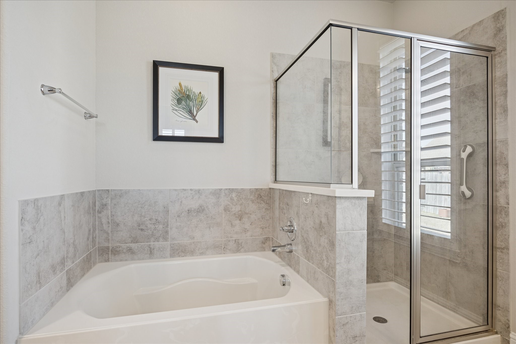 4615 Verbena Valley Way Spring, TX 77388 - Photo 14 of 25 In the primary bathroom space, there is an oversized shower as well as a large soaking tub. The shower has a grab bar for safety.