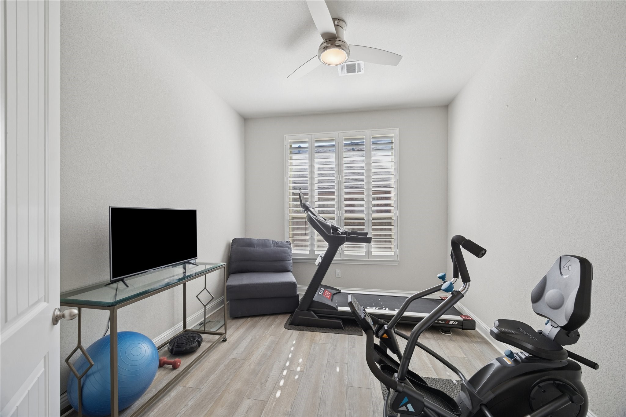 4615 Verbena Valley Way Spring, TX 77388 - Photo 16 of 25 This is the study/library with double doors off the entry way. The homeowner currently uses it as a workout gym. There is plenty of room for a treadmill, workout bike, chair and television and that ceiling fan will keep you cool whether it is a workout room, study, or playroom. Your imagination is the only limiting factor for what you choose to do with this space.