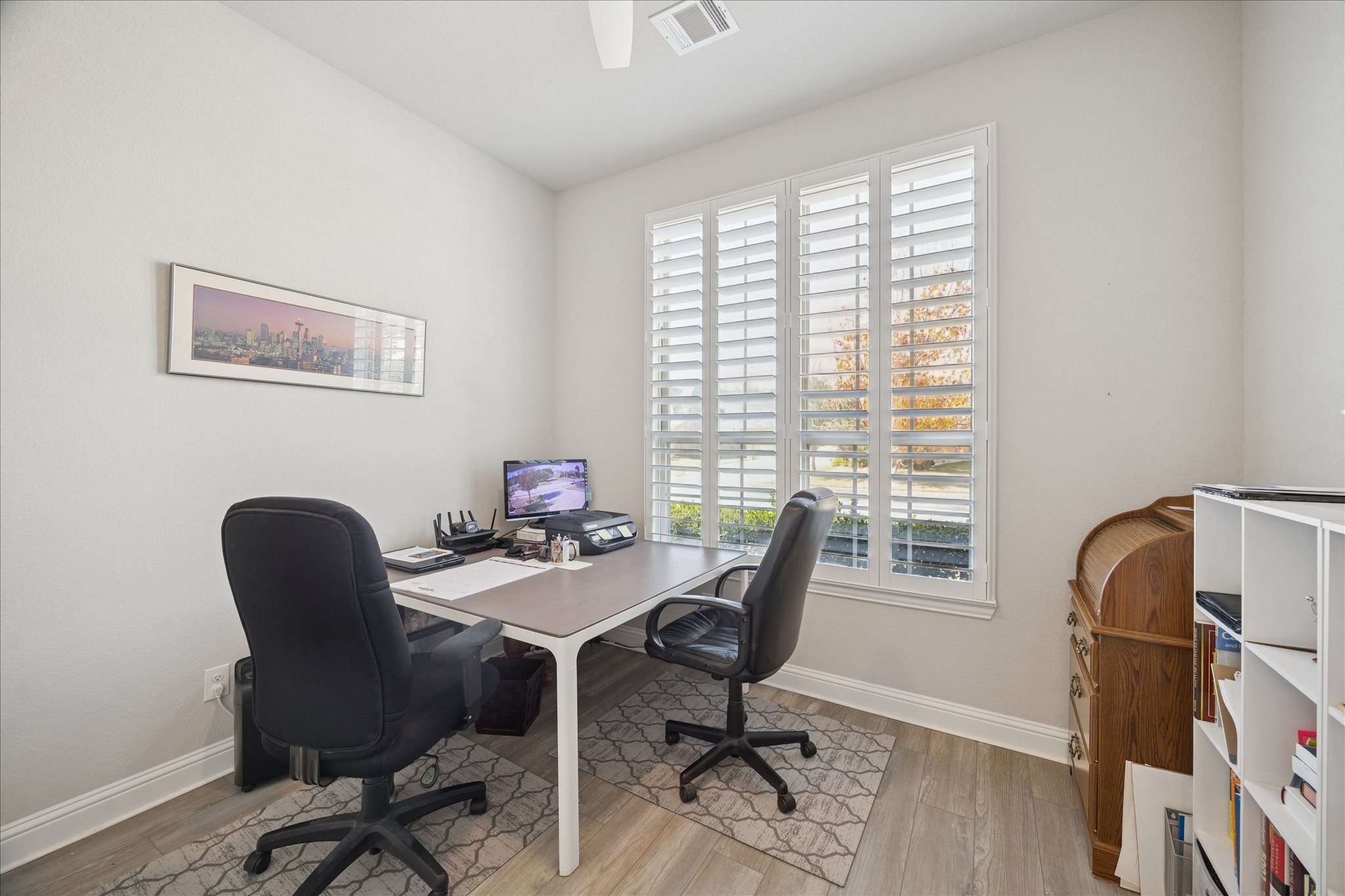 4615 Verbena Valley Way Spring, TX 77388 - Photo 17 of 25 Front bedroom is utilized by the homeowner as an office. It features Luxury Vinyl flooring, ceiling fan, plantation shutters. Located to the right of the entryway, there is a full bathroom next to it. This may be a perfect space for guests with privacy, natural light shining in. All of the bedrooms have ample closets.
