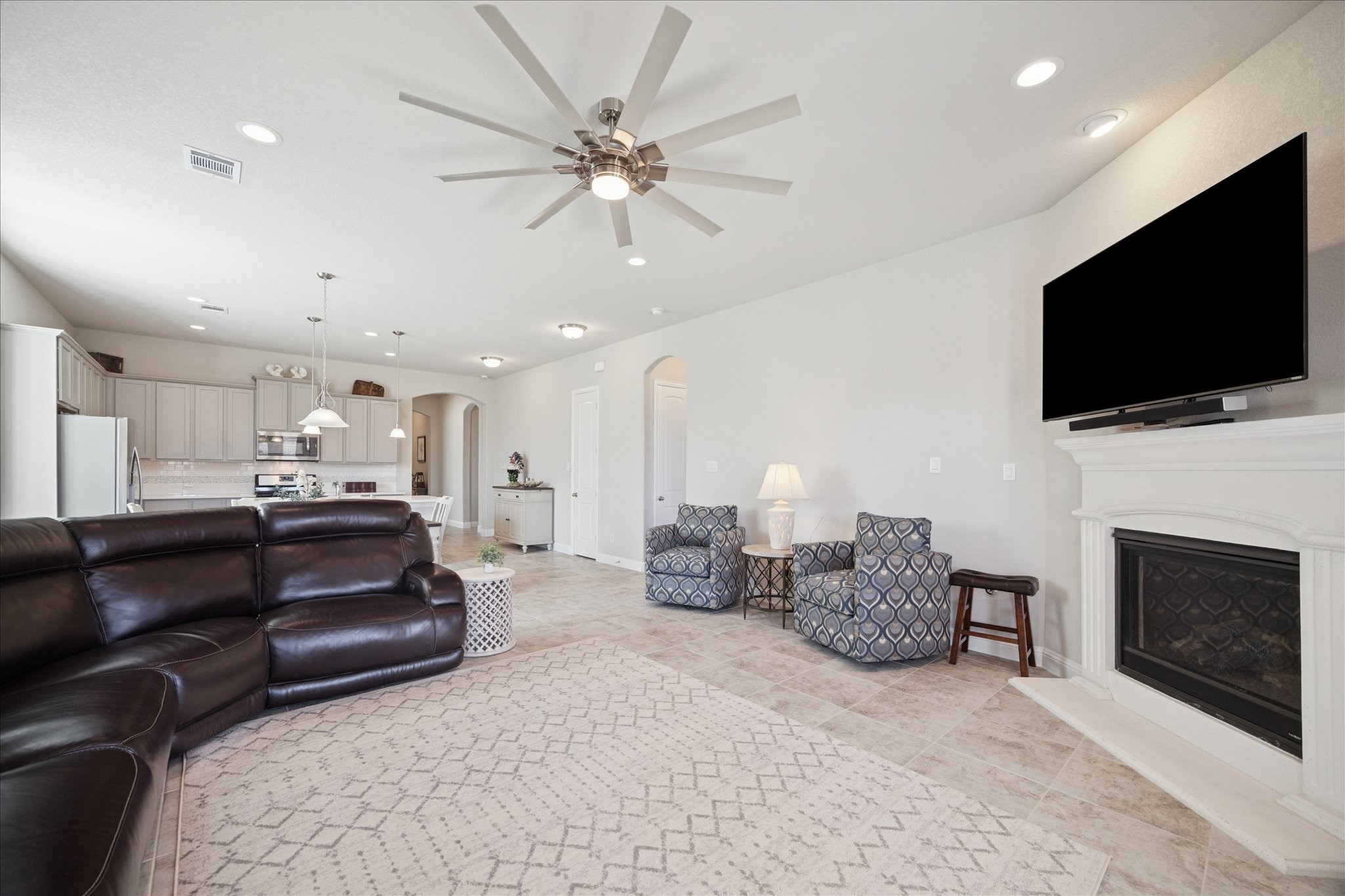 4615 Verbena Valley Way Spring, TX 77388 - Photo 8 of 25 Open concept living includes recessed can lighting and a beautiful gas fireplace. Tile floors and large ceiling fan make this a comfortable place to sit a while!