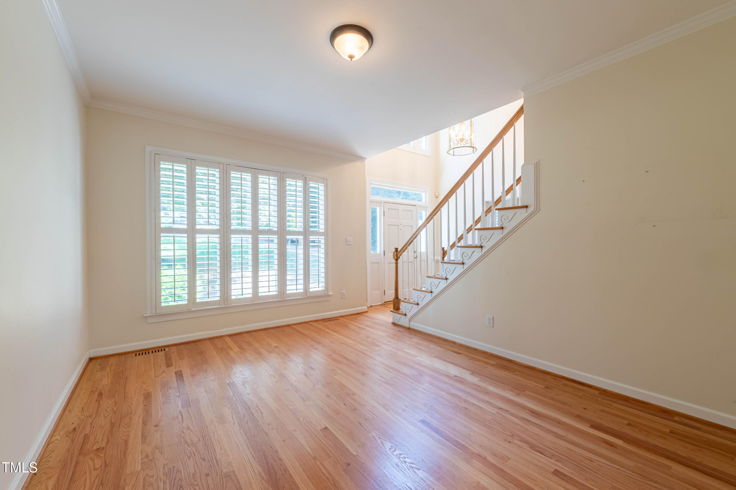 3009 Walton Heath Court Raleigh, NC 27612 - Photo 11 of 40 a view of an empty room with wooden floor and fan