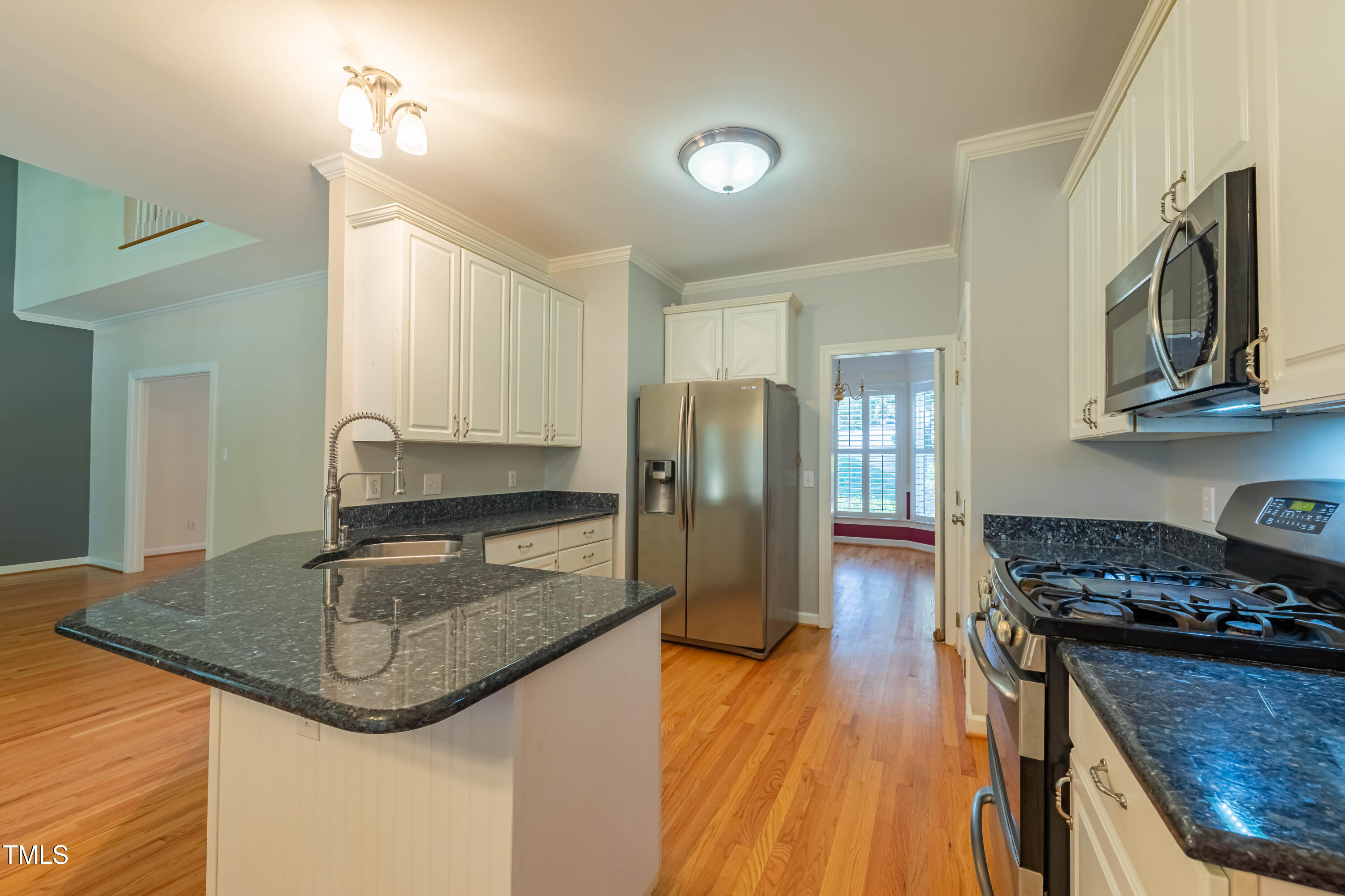3009 Walton Heath Court Raleigh, NC 27612 - Photo 19 of 40 a kitchen with stainless steel appliances granite countertop a sink stove and refrigerator