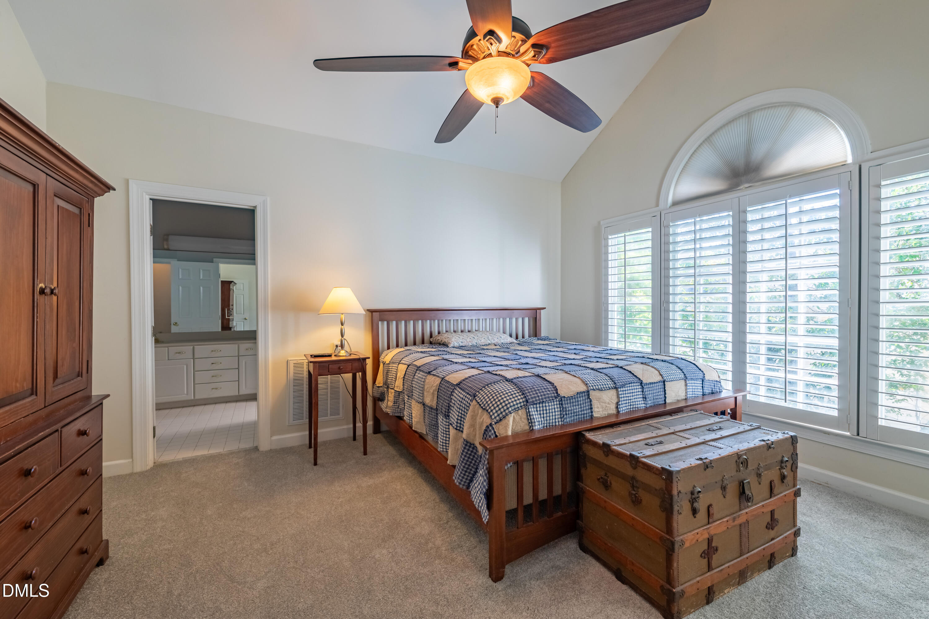 3009 Walton Heath Court Raleigh, NC 27612 - Photo 21 of 40 a spacious bedroom with a bed and a chandelier