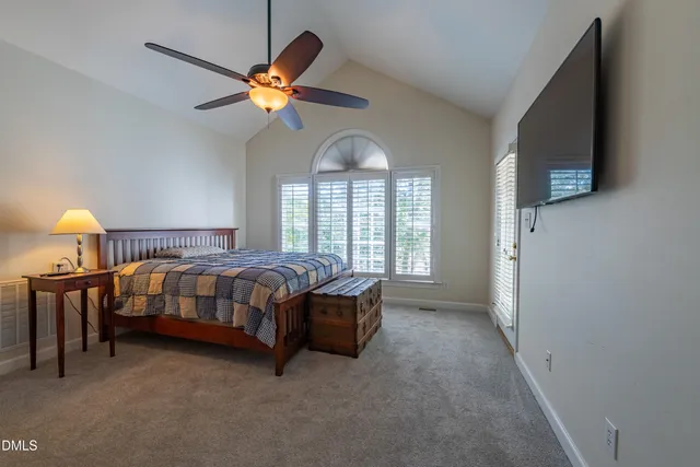 a bedroom with a bed and a ceiling fan