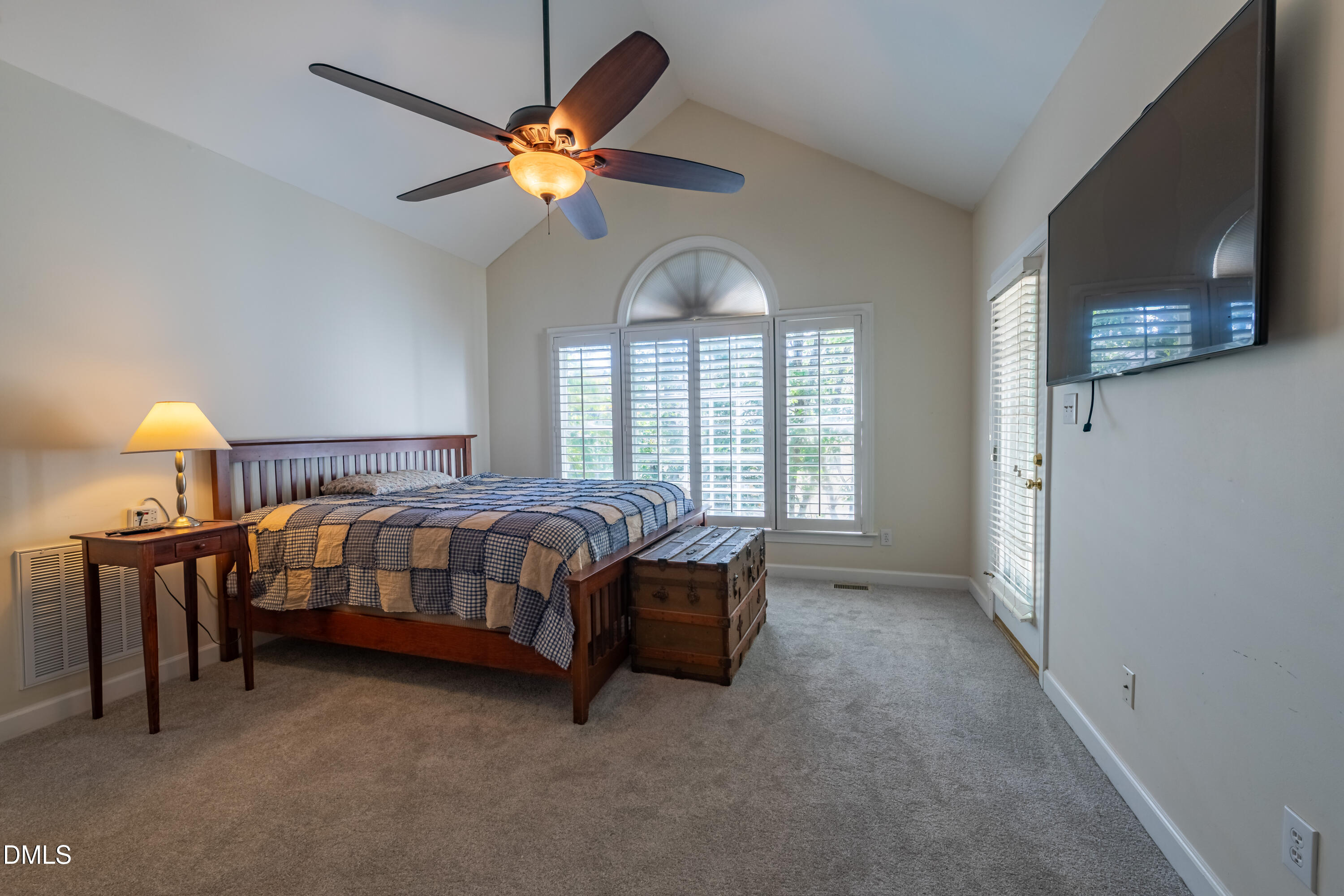 3009 Walton Heath Court Raleigh, NC 27612 - Photo 24 of 40 a bedroom with a bed and a chandelier