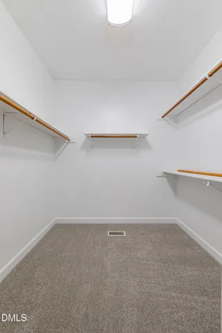 a spacious bathroom with a double vanity sink mirror and bathtub