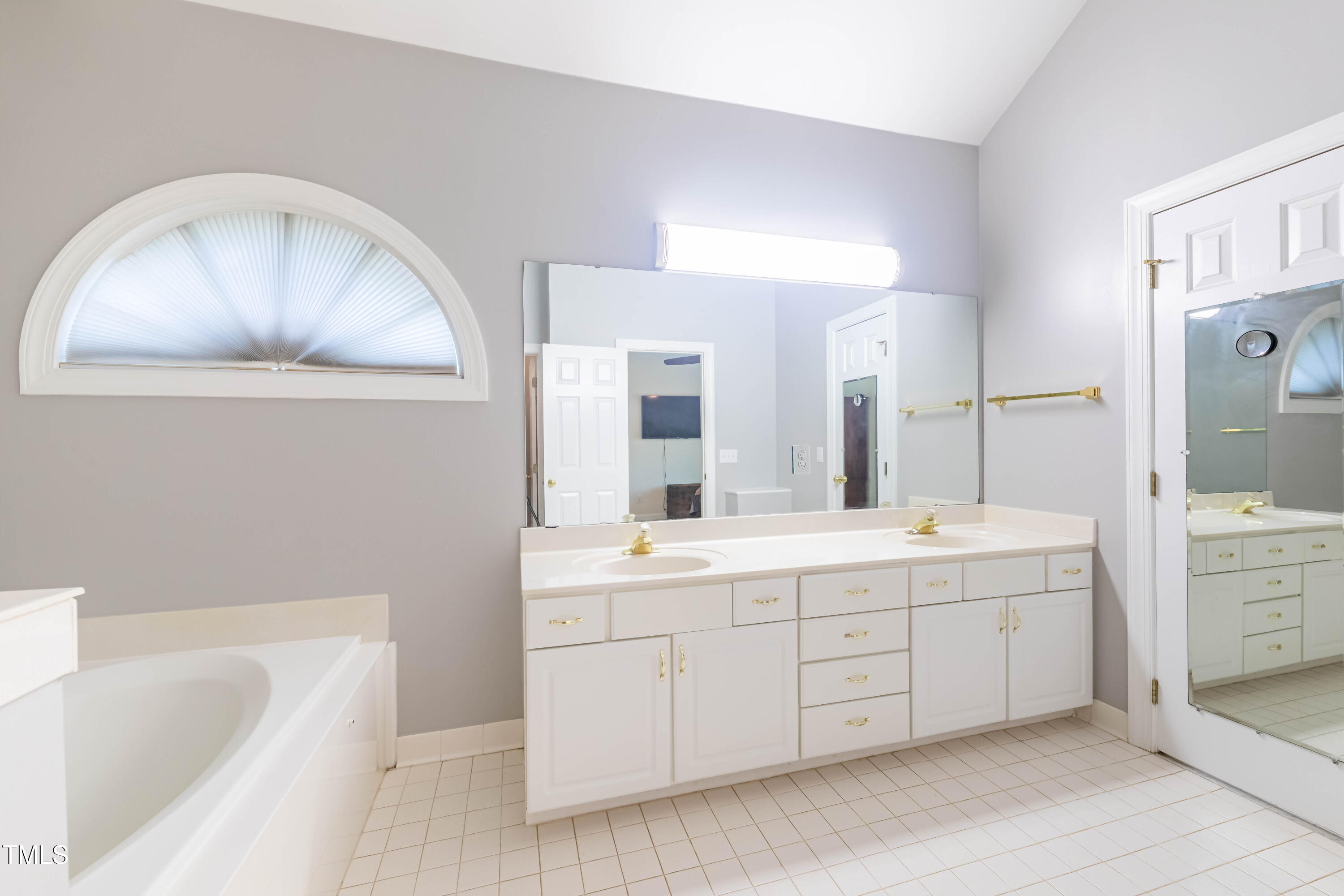 3009 Walton Heath Court Raleigh, NC 27612 - Photo 27 of 40 a spacious bathroom with a double vanity sink mirror and bathtub