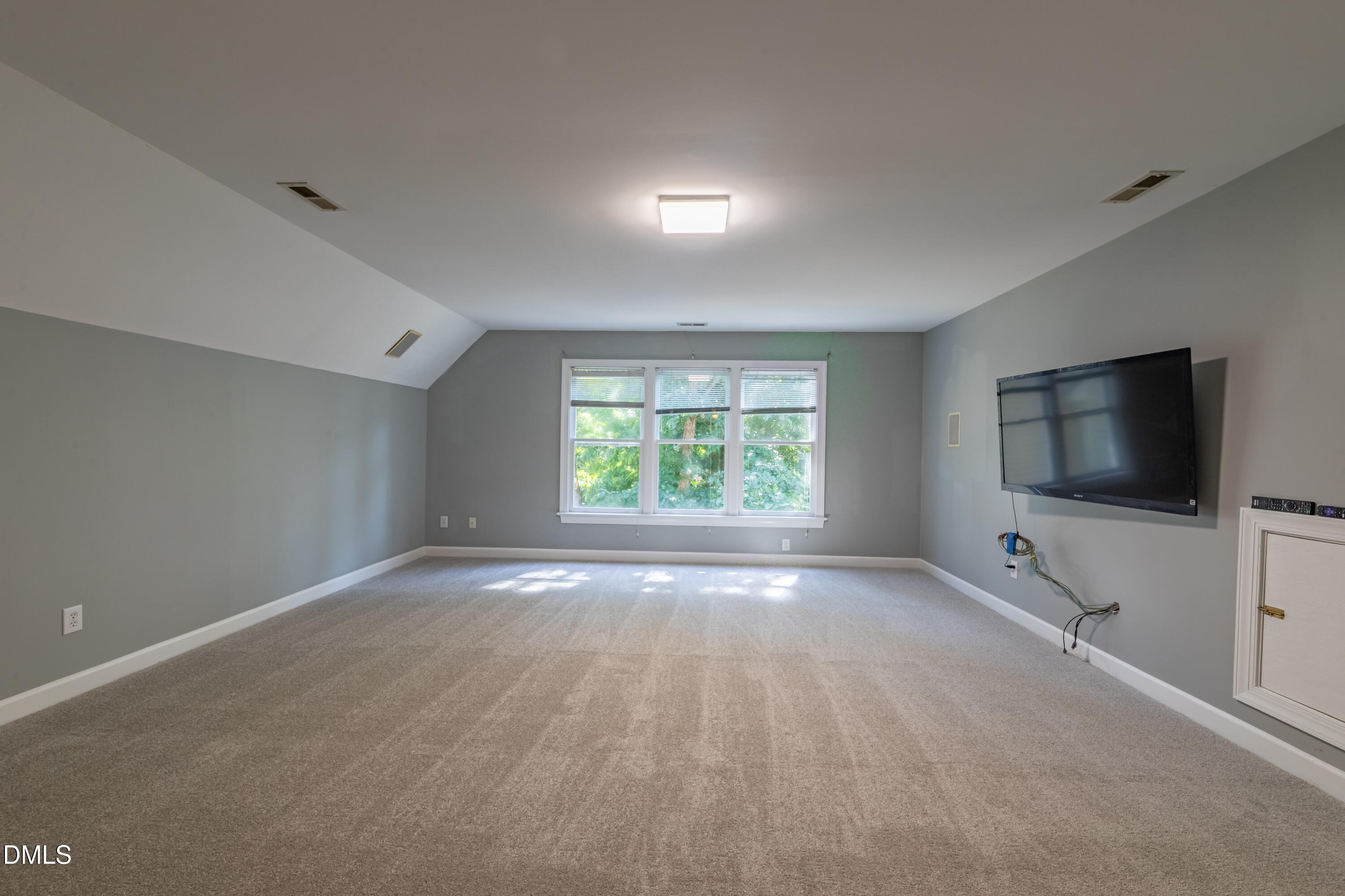 3009 Walton Heath Court Raleigh, NC 27612 - Photo 32 of 40 an empty room with windows and tv