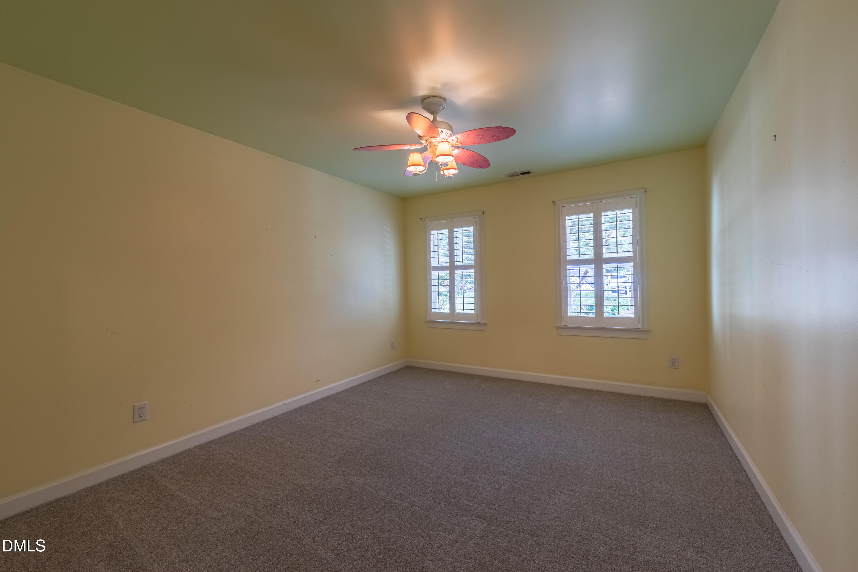 3009 Walton Heath Court Raleigh, NC 27612 - Photo 37 of 40 an empty room with windows and chandelier fan