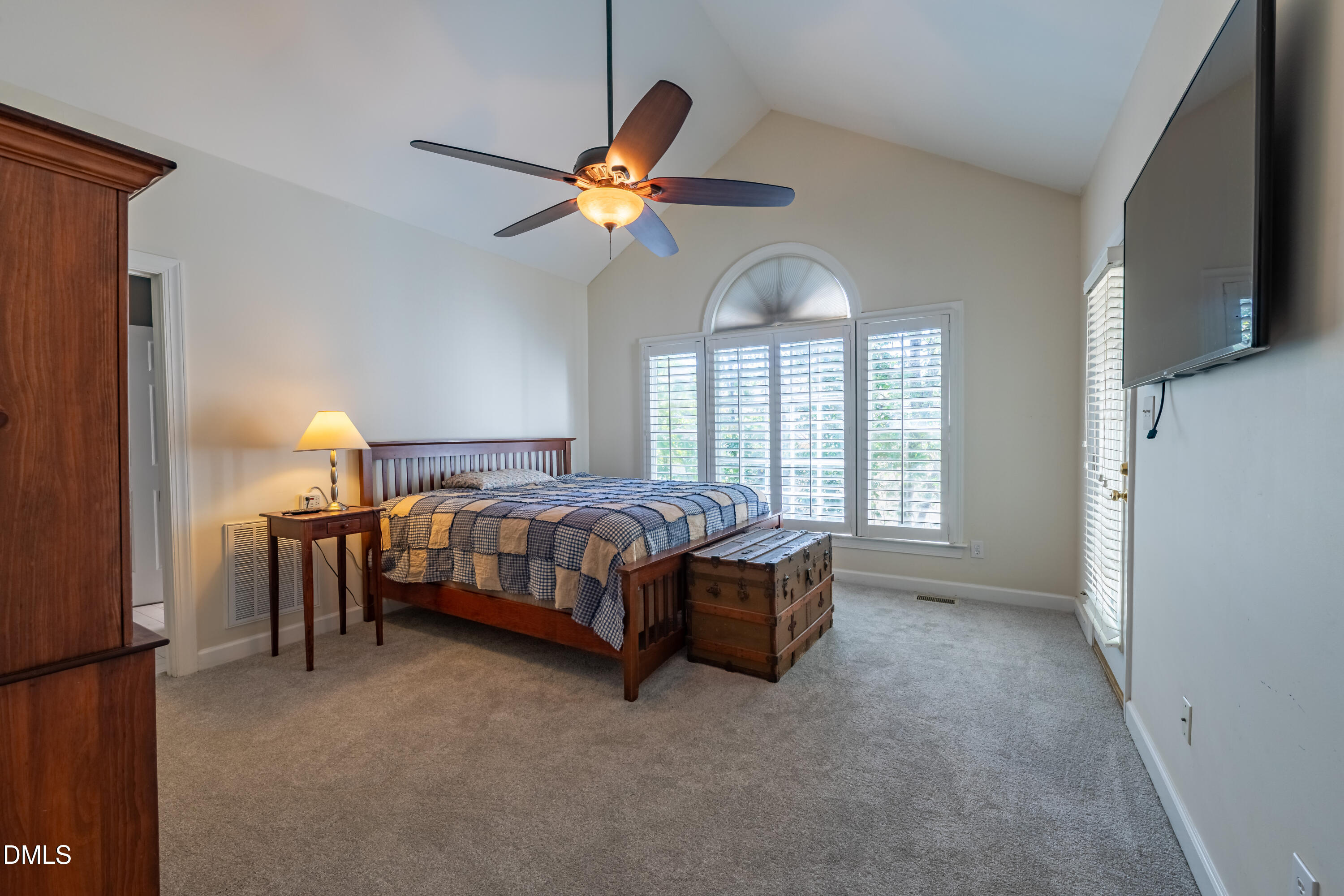 3009 Walton Heath Court Raleigh, NC 27612 - Photo 38 of 40 a bedroom with a bed and a chandelier