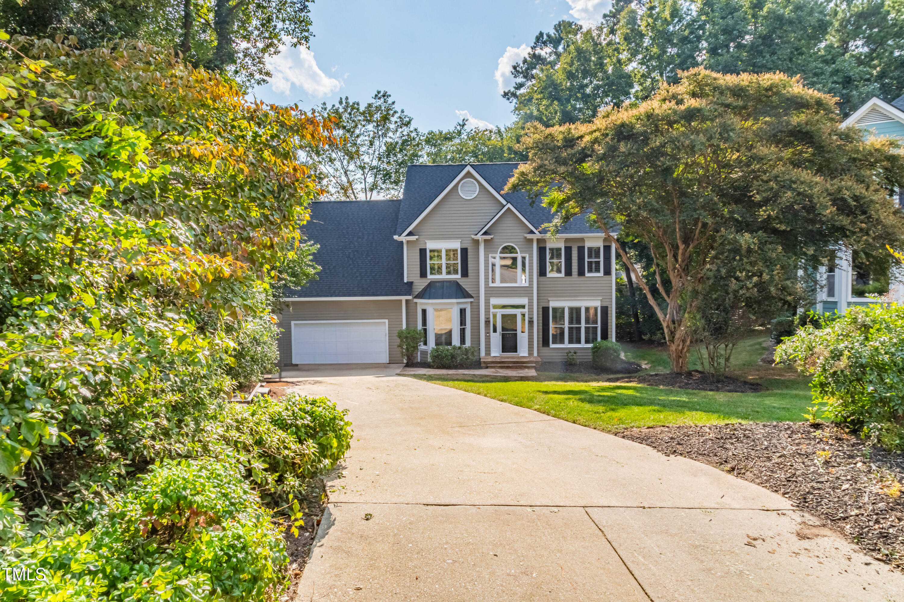 3009 Walton Heath Court Raleigh, NC 27612 - Photo 5 of 40 a front view of a house with a yard and trees