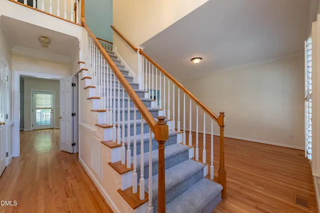a view of entryway and hall with wooden floor