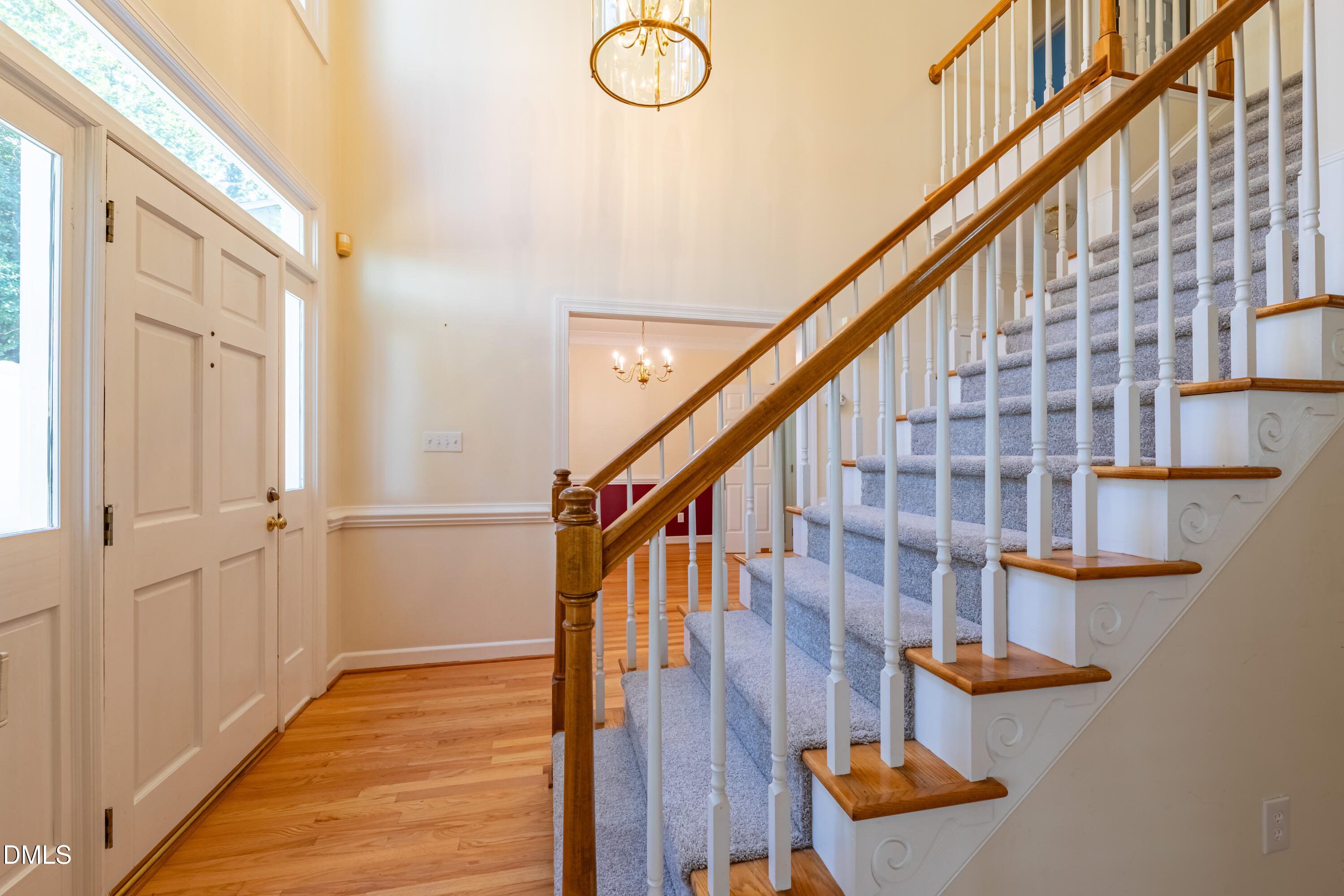 3009 Walton Heath Court Raleigh, NC 27612 - Photo 9 of 40 a view of staircase with wooden floor and cabinets