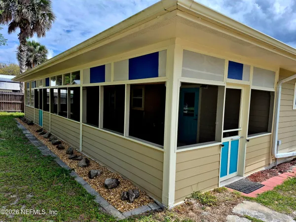 a view of a small house with backyard