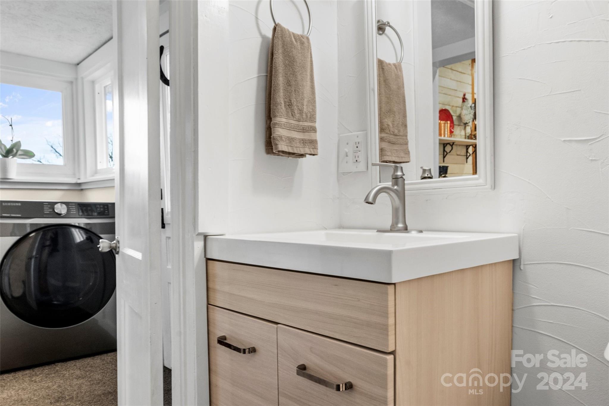 24 Brookside Street Clyde, NC 28721 - Photo 20 of 40 a bathroom with a sink and a mirror