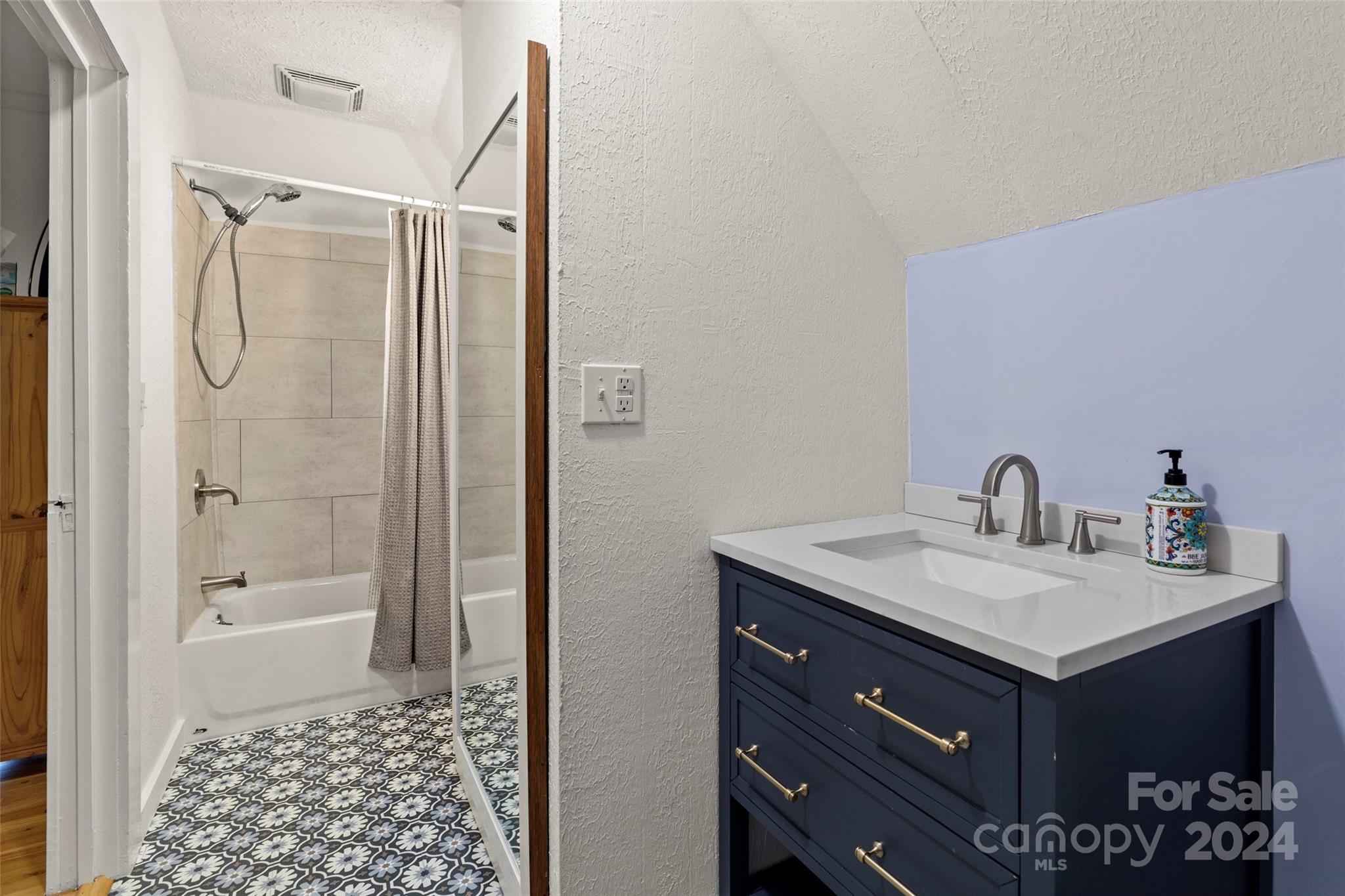 24 Brookside Street Clyde, NC 28721 - Photo 27 of 40 a bathroom with a sink a toilet and shower