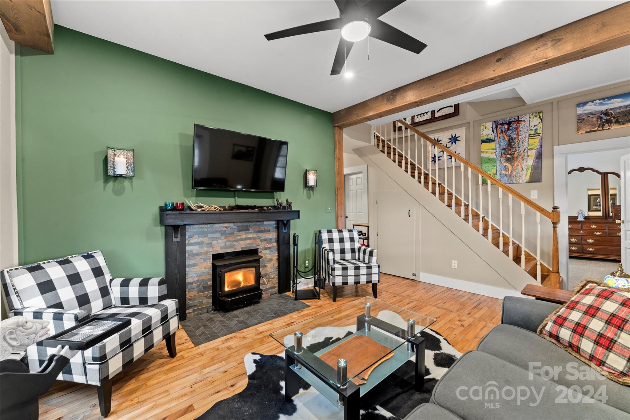24 Brookside Street Clyde, NC 28721 - Photo 6 of 40 a living room with furniture a flat screen tv and a fireplace