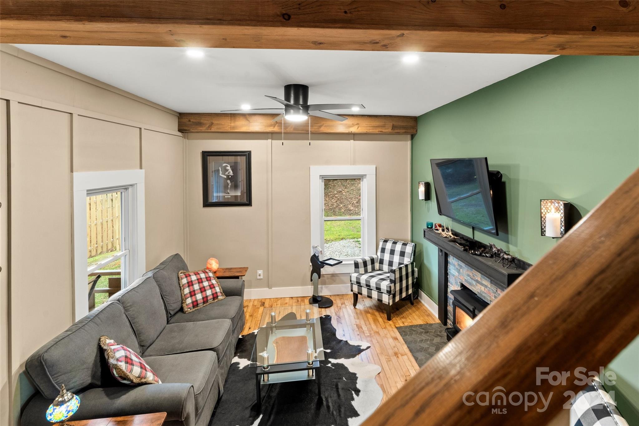 24 Brookside Street Clyde, NC 28721 - Photo 8 of 40 a living room with furniture and a flat screen tv