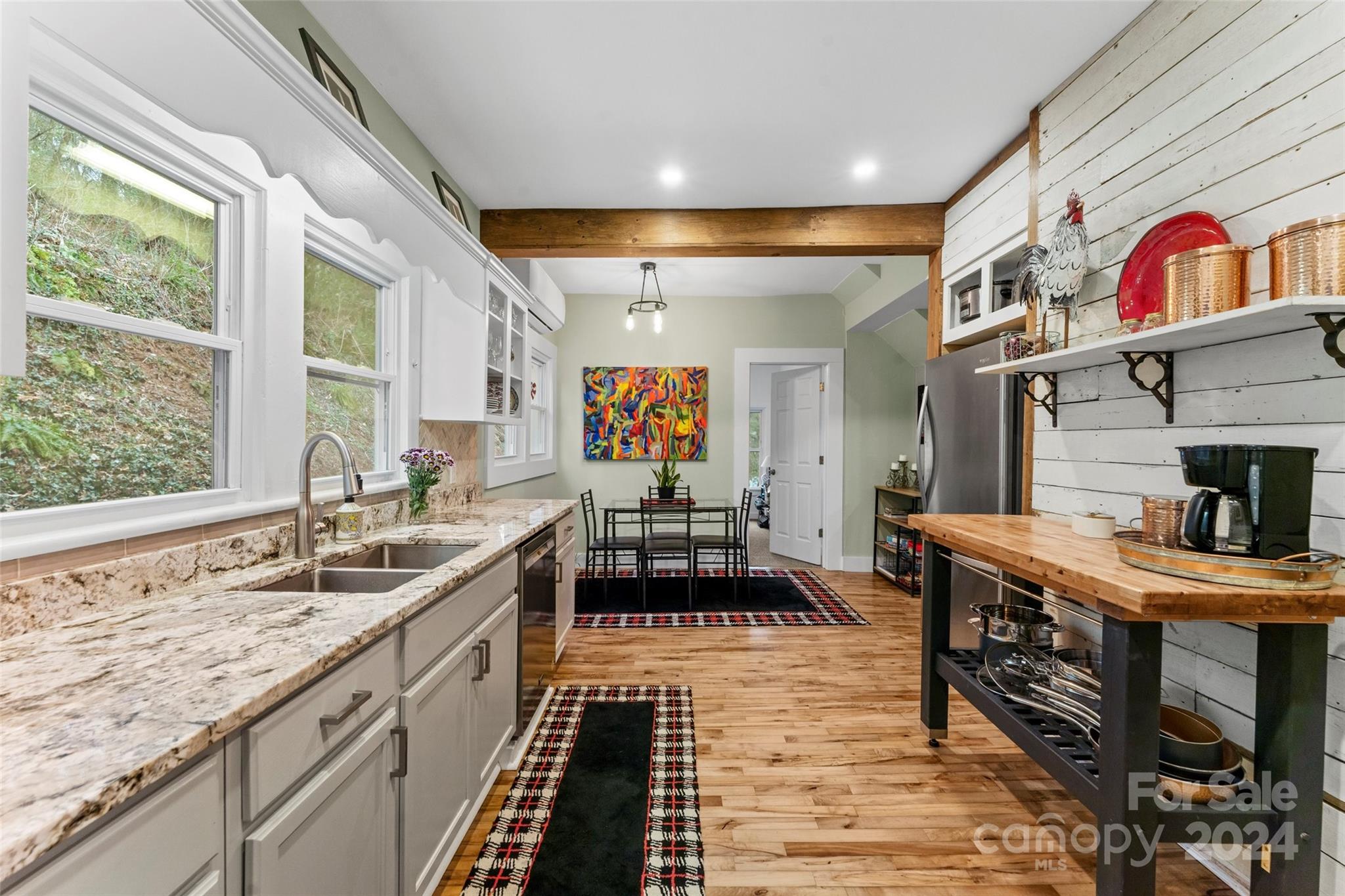 24 Brookside Street Clyde, NC 28721 - Photo 10 of 40 a large hall with stainless steel appliances granite countertop a sink and cabinets
