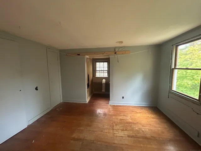 an empty room with windows and closet