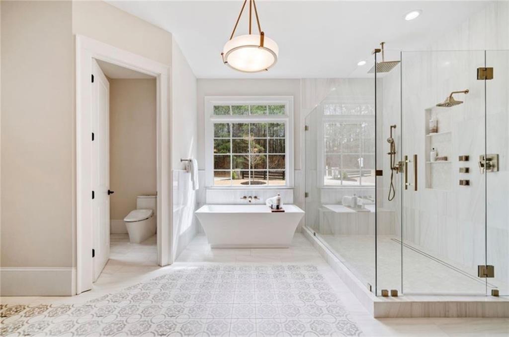 310 Timberview Trail Alpharetta, GA 30004 - Photo 31 of 71 a spacious bathroom with a bathtub shower and toilet