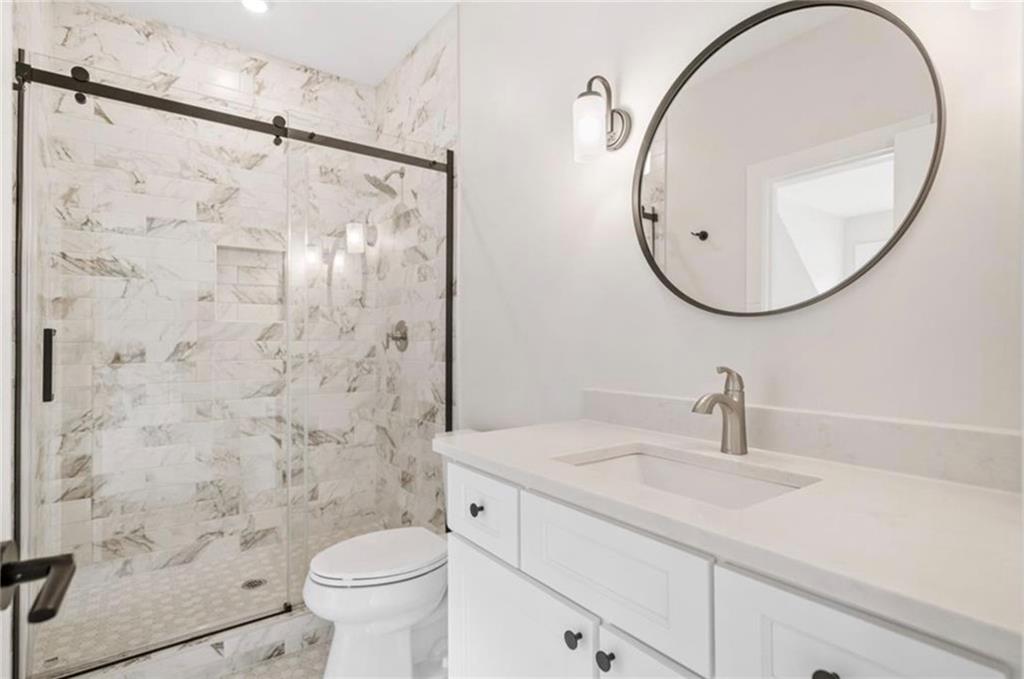 310 Timberview Trail Alpharetta, GA 30004 - Photo 36 of 71 a bathroom with a sink a toilet and a mirror