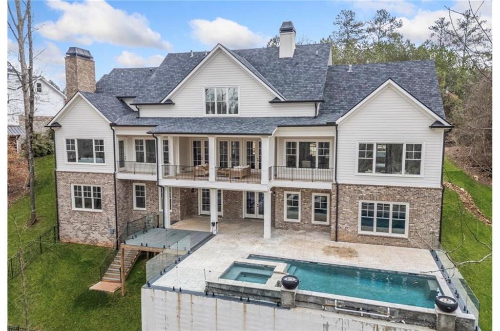 310 Timberview Trail Alpharetta, GA 30004 - Photo 63 of 71 a front view of residential houses with yard and trees in the background
