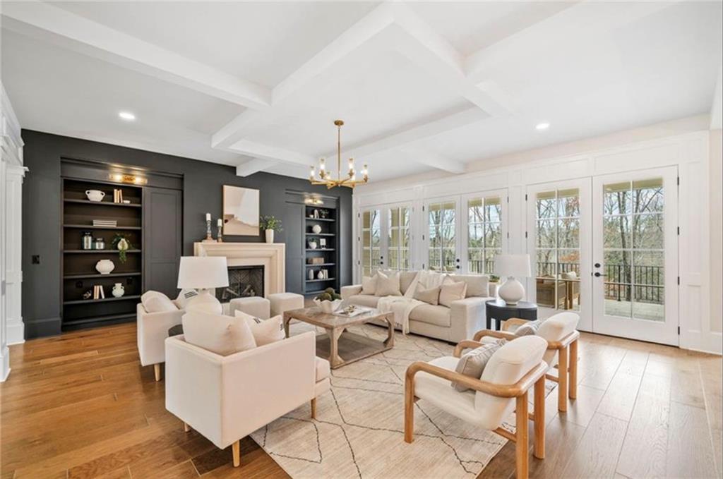 310 Timberview Trail Alpharetta, GA 30004 - Photo 7 of 71 a living room with fireplace furniture and a wooden floor