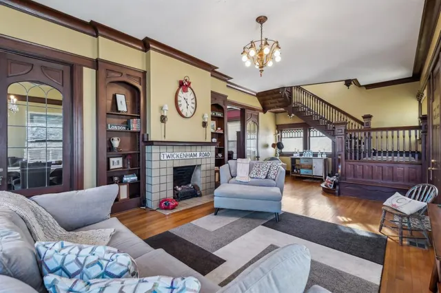 a living room with furniture a fireplace and a chandelier