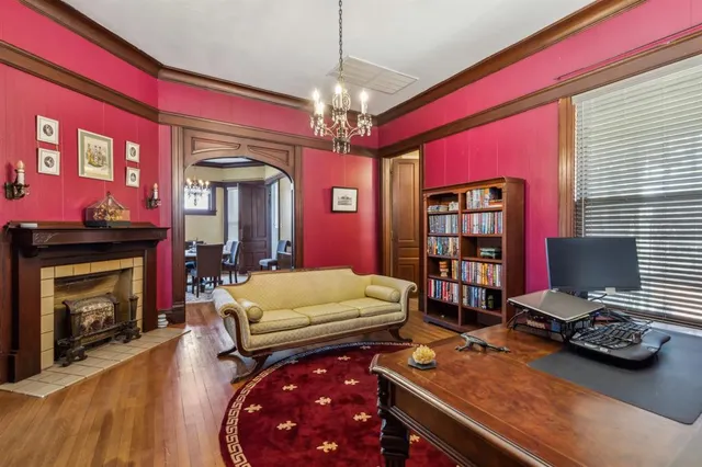 a room with furniture a chandelier and a fireplace