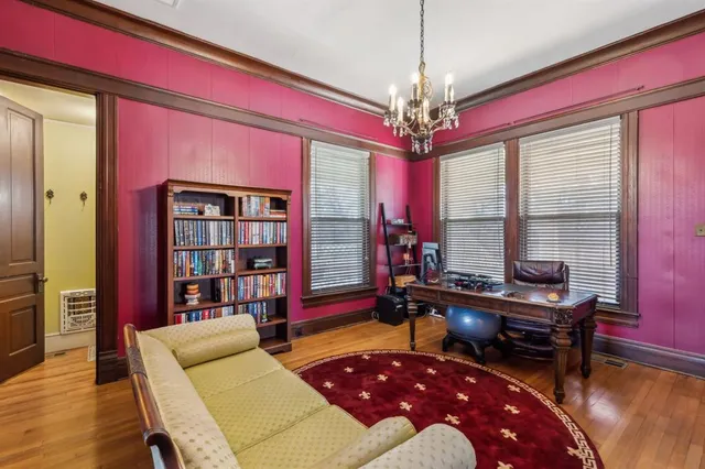 a living room with furniture and a chandelier