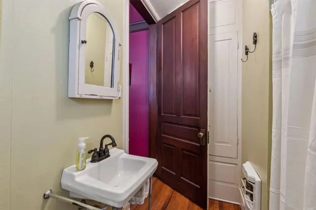 a bathroom with a sink a mirror and shower