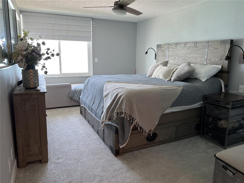 7100 Sunset Way, Unit PH5 St. Pete Beach, FL 33706 - Photo 16 of 32 a bedroom with a bed and a window