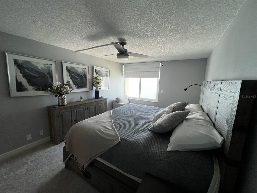 7100 Sunset Way, Unit PH5 St. Pete Beach, FL 33706 - Photo 17 of 32 a living room with furniture and a flat screen tv