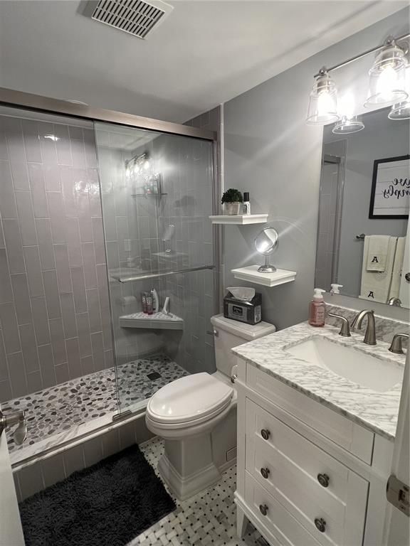 7100 Sunset Way, Unit PH5 St. Pete Beach, FL 33706 - Photo 20 of 32 a bathroom with a sink a toilet and shower