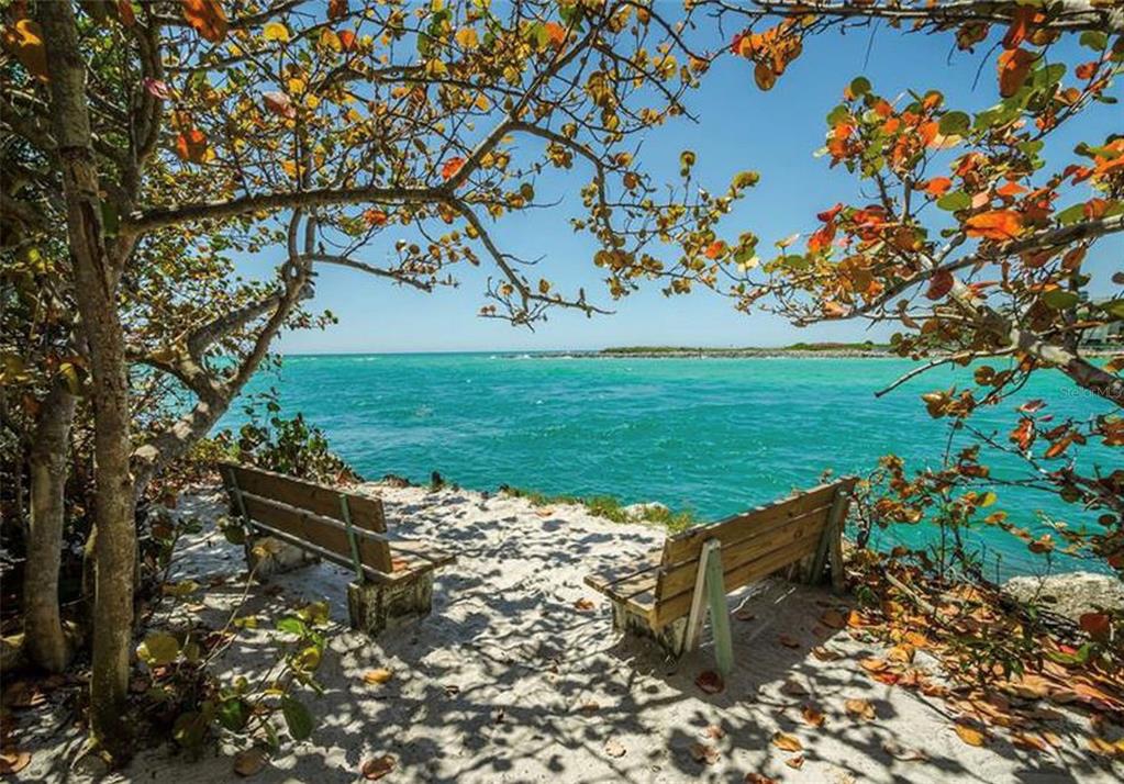 7100 Sunset Way, Unit PH5 St. Pete Beach, FL 33706 - Photo 23 of 32 a view of a bench in a garden