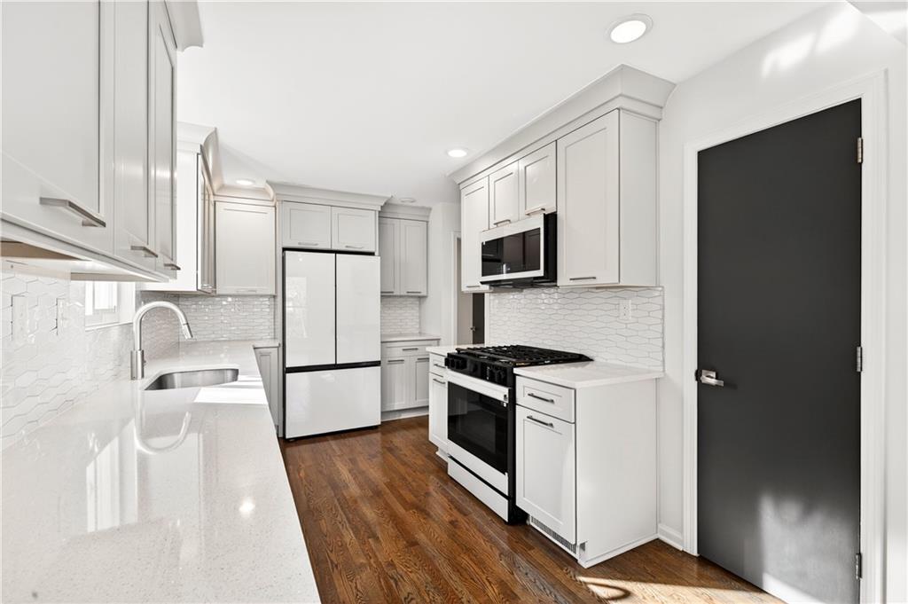 Undisclosed Address Brookhaven, GA 30319 - Photo 12 of 63 a kitchen with stainless steel appliances a refrigerator stove and microwave