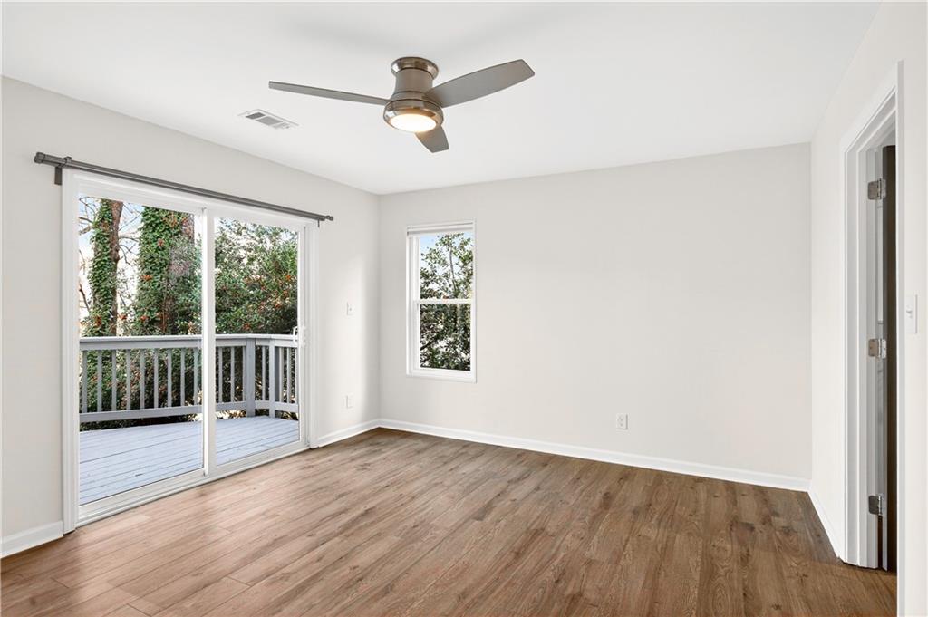 Undisclosed Address Brookhaven, GA 30319 - Photo 33 of 63 an empty room with wooden floor fan and windows