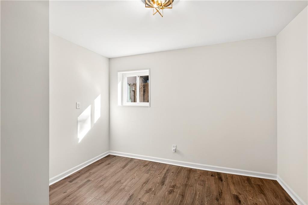 Undisclosed Address Brookhaven, GA 30319 - Photo 49 of 63 a view of an empty room with a window and wooden floor