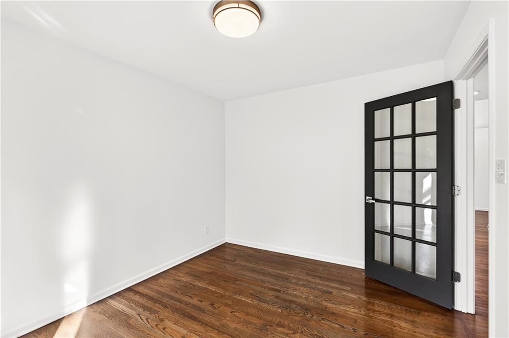 Undisclosed Address Brookhaven, GA 30319 - Photo 7 of 63 a view of empty room with wooden floor and fan