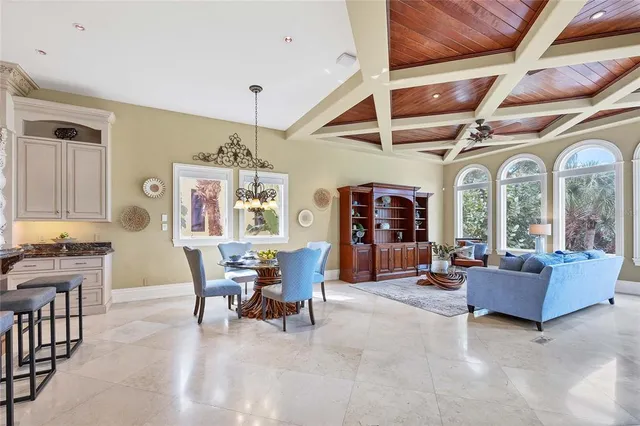 a view of a dining room with furniture a chandelier and wooden floor