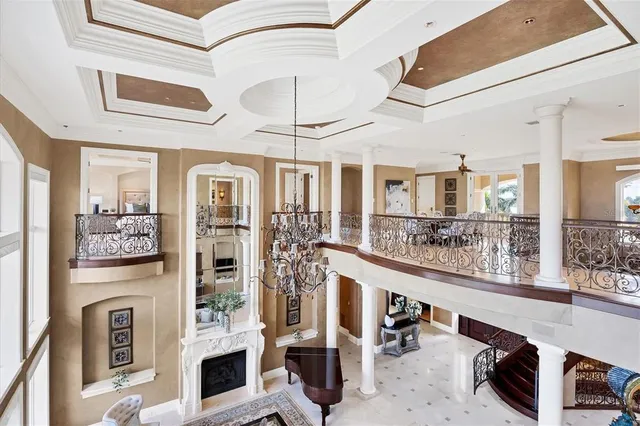 a large white kitchen with stainless steel appliances kitchen island granite countertop a refrigerator and cabinets