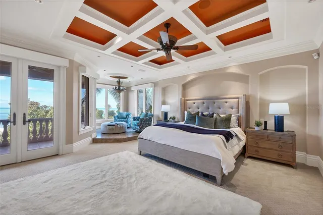 a spacious bedroom with a bed couch and a ceiling fan
